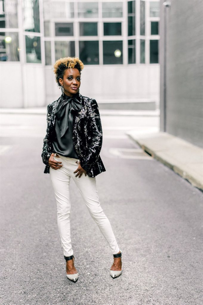Kerry-Ann Flowers, entrepreneur of of K. Flowers Designs posing for a photo on a Pittsburgh city street
