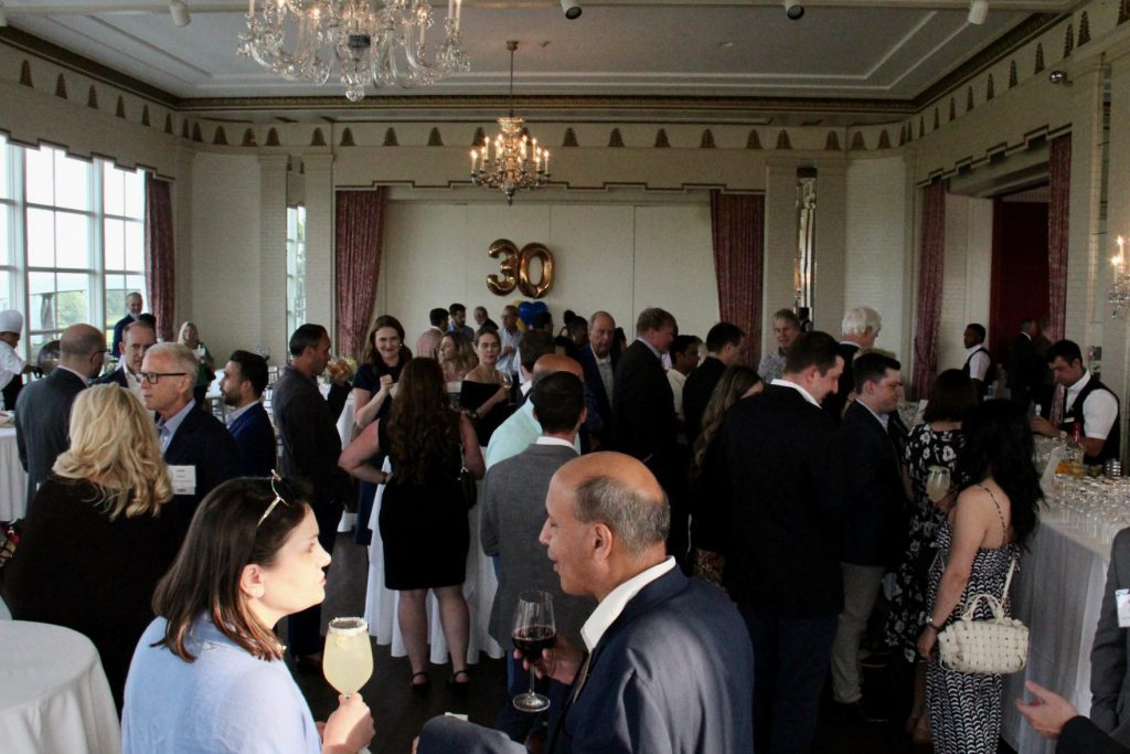 Large group of people talking and networking at the IEE's Summer Social 2023
