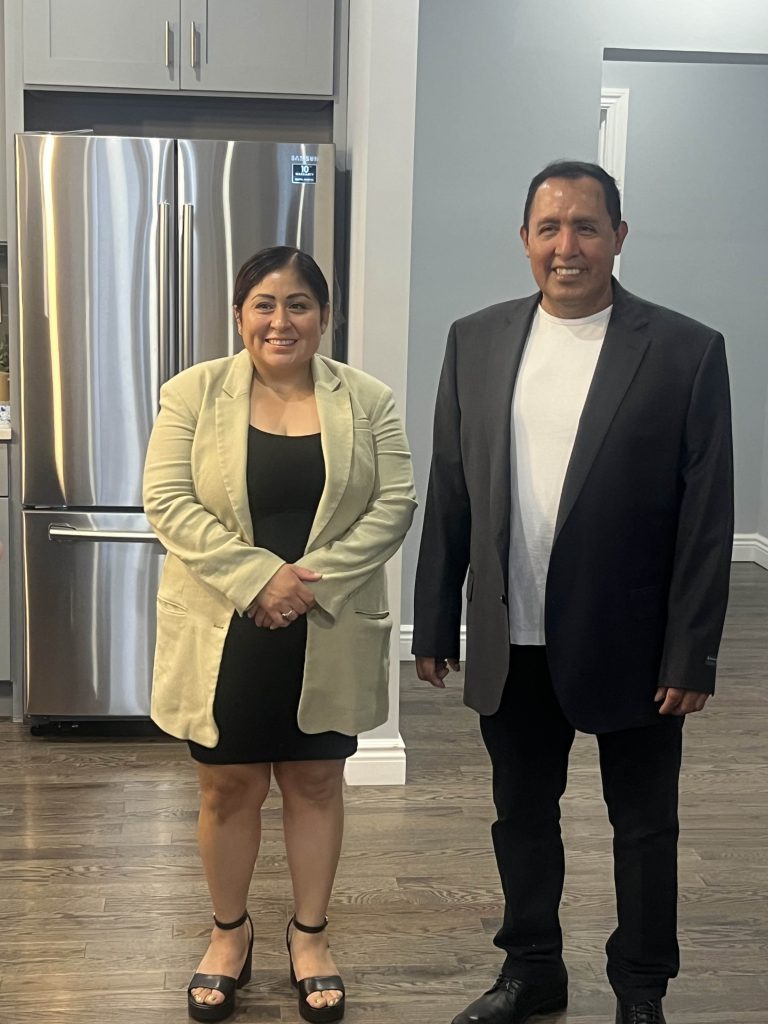 Entrepreneur couple posing for a photo at their new rental property business.